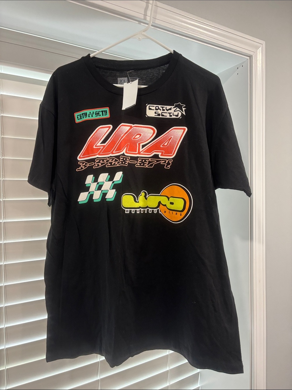 Lira Black Graphic Short Sleeve Tee with Red, Yellow and Green Accents